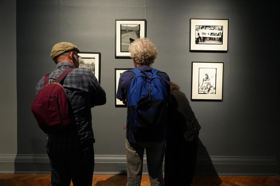 dos personas viendo cuadros de la exposición
